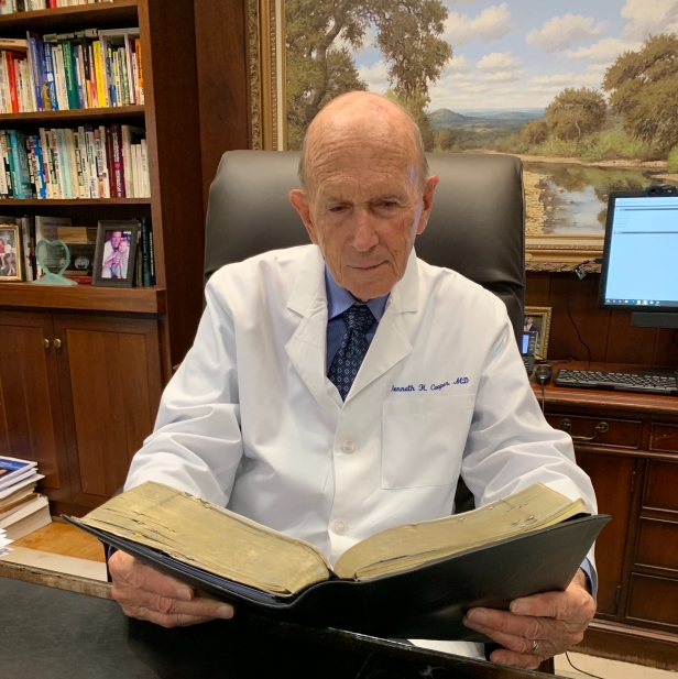 Dr. Kenneth Cooper reading Bible at desk